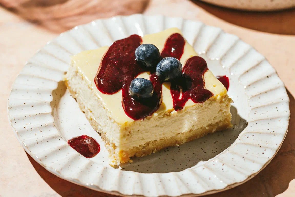 Lemon Ricotta Cheesecake Bars with Berry Sauce
